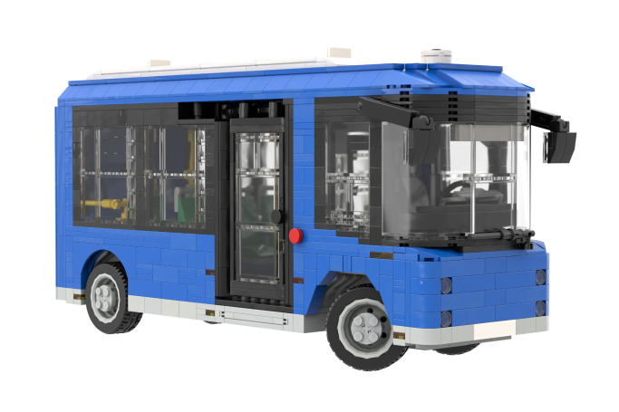 Autobús de juguete azul con ventanas transparentes y detalles interiores.